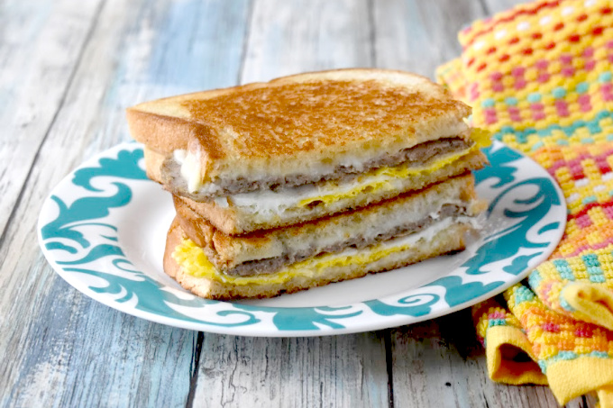 Instead of using a toaster, the bread in this Breakfast Grilled Cheese is buttered and toasted in the pan with the egg, sausage, and cheese all melted together.