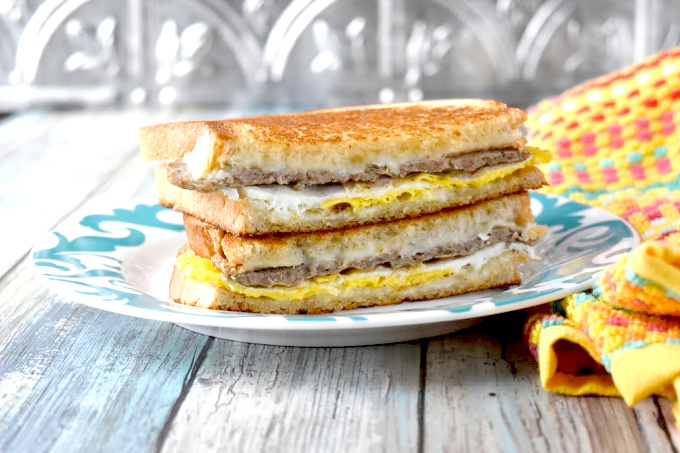 Instead of using a toaster, the bread in this Breakfast Grilled Cheese is buttered and toasted in the pan with the egg, sausage, and cheese all melted together.
