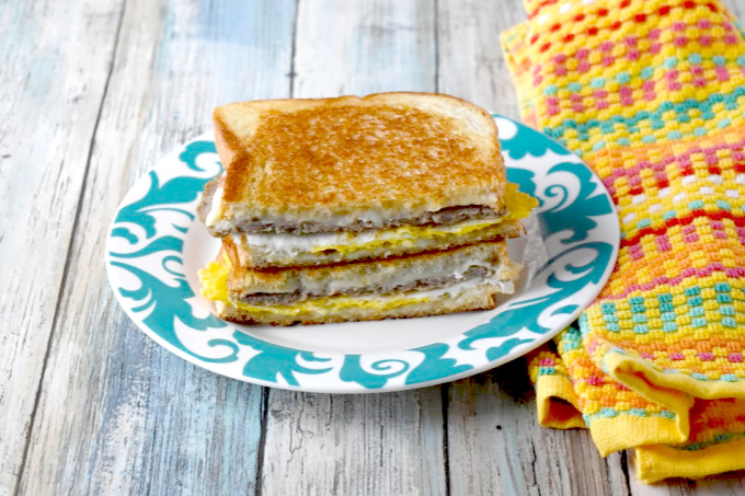 Instead of using a toaster, the bread in this Breakfast Grilled Cheese is buttered and toasted in the pan with the egg, sausage, and cheese all melted together.