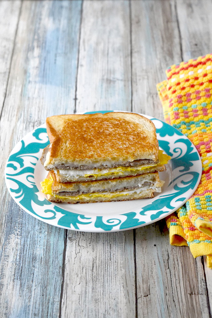 Instead of using a toaster, the bread in this Breakfast Grilled Cheese is buttered and toasted in the pan with the egg, sausage, and cheese all melted together.