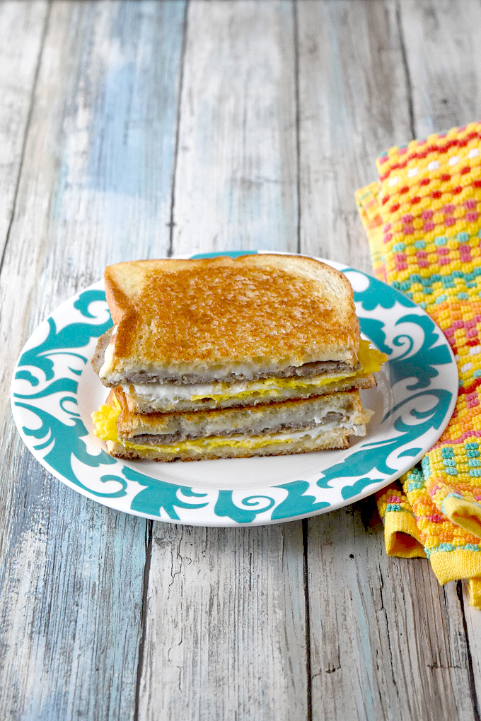 Instead of using a toaster, the bread in this Breakfast Grilled Cheese is buttered and toasted in the pan with the egg, sausage, and cheese all melted together.