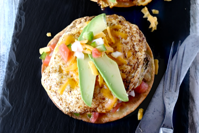 You can prepare everything but eggs ahead of time.  Breakfast Tostadas are not only delicious, but kicked up with spice and topped with cheese, cool crema, and creamy avocados.