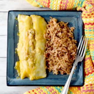 Easy Green Chile Chicken Enchiladas are super scrumptious, super easy, and almost everything comes from your pantry. The chicken can either be canned or leftover roasted chicken. Either way these are DE-licious. #OurFamilyTable
