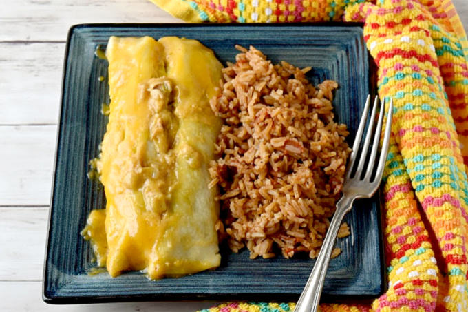 Easy Green Chile Chicken Enchiladas are super scrumptious, super easy, and almost everything comes from your pantry.  The chicken can either be canned or leftover roasted chicken.  Either way these are DE-licious. #OurFamilyTable