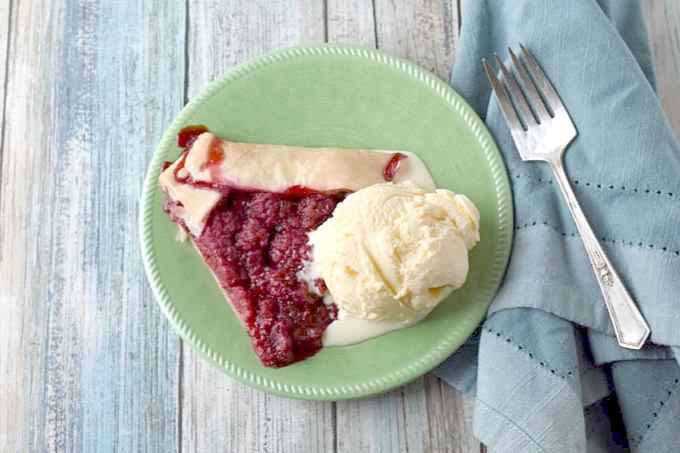 With a handful of ingredients, you can have this Raspberry Crostata on your barbecue table.  Topped with vanilla ice cream, it's perfect for summer! #BerryWeek