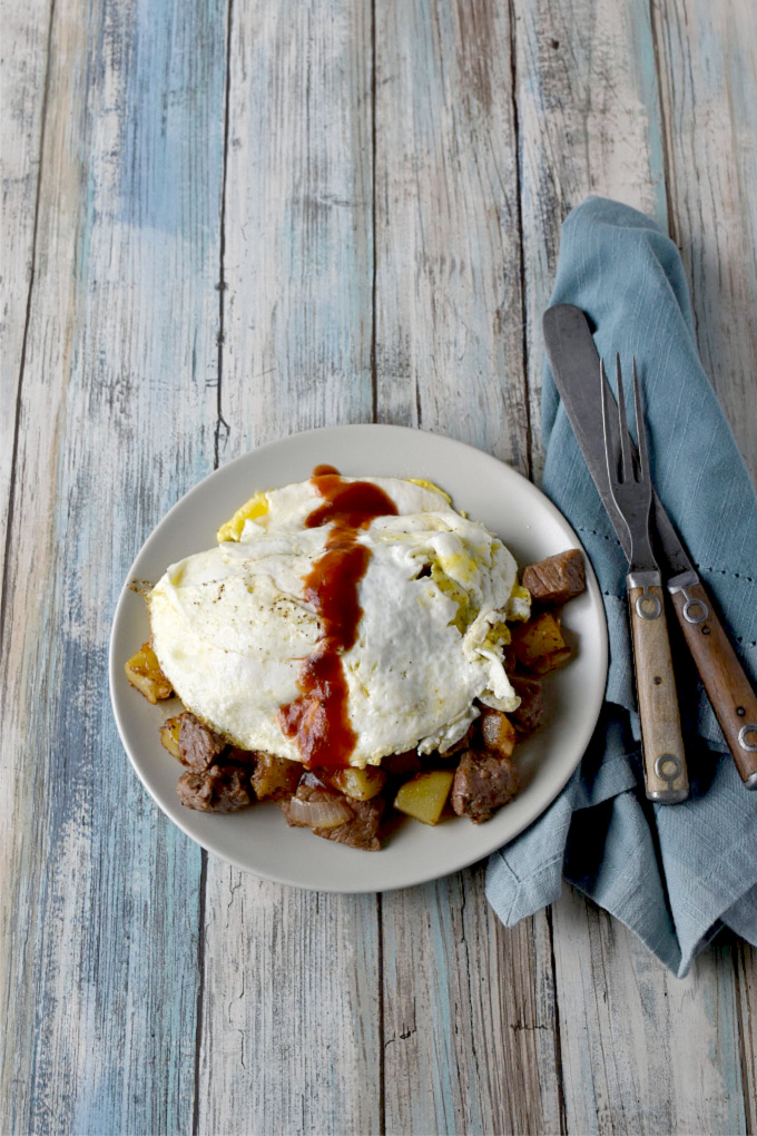 Steak and Potato Hash takes steak and eggs to a whole new level!  Kicked up with steak seasoning and a drizzle of steak sauce, it’s a hearty breakfast everyone will love. #BrunchWeek