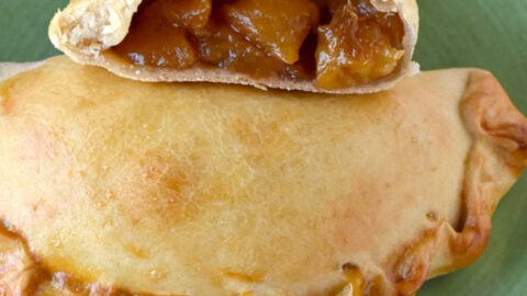 Bourbon Peach Empanadas are light, crispy, and full of summer peach flavor. There’s a hint of bourbon flavor in the brown sugar sauce. #SummerDessertWeek