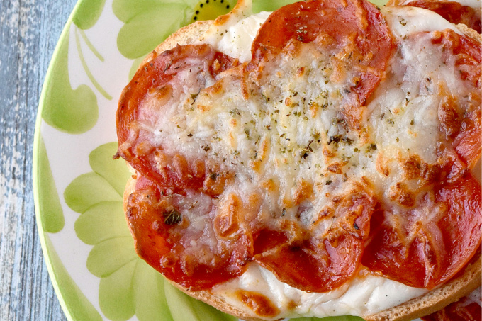 Pizza Toast is such a deliciously simple snack for any time! This one is topped with pepperoni and cheese, but you could top yours with anything you want! #BacktoSchoolTreats