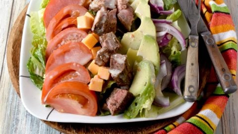 Blackened Steak Cobb Salad has a bit of spice and heat on top of crisp greens with onions, tomatoes, avocadoes, cheese, and hard-boiled eggs. It’s a hearty dinner salad that is quick and easy to make. #FarmersMarketWeek