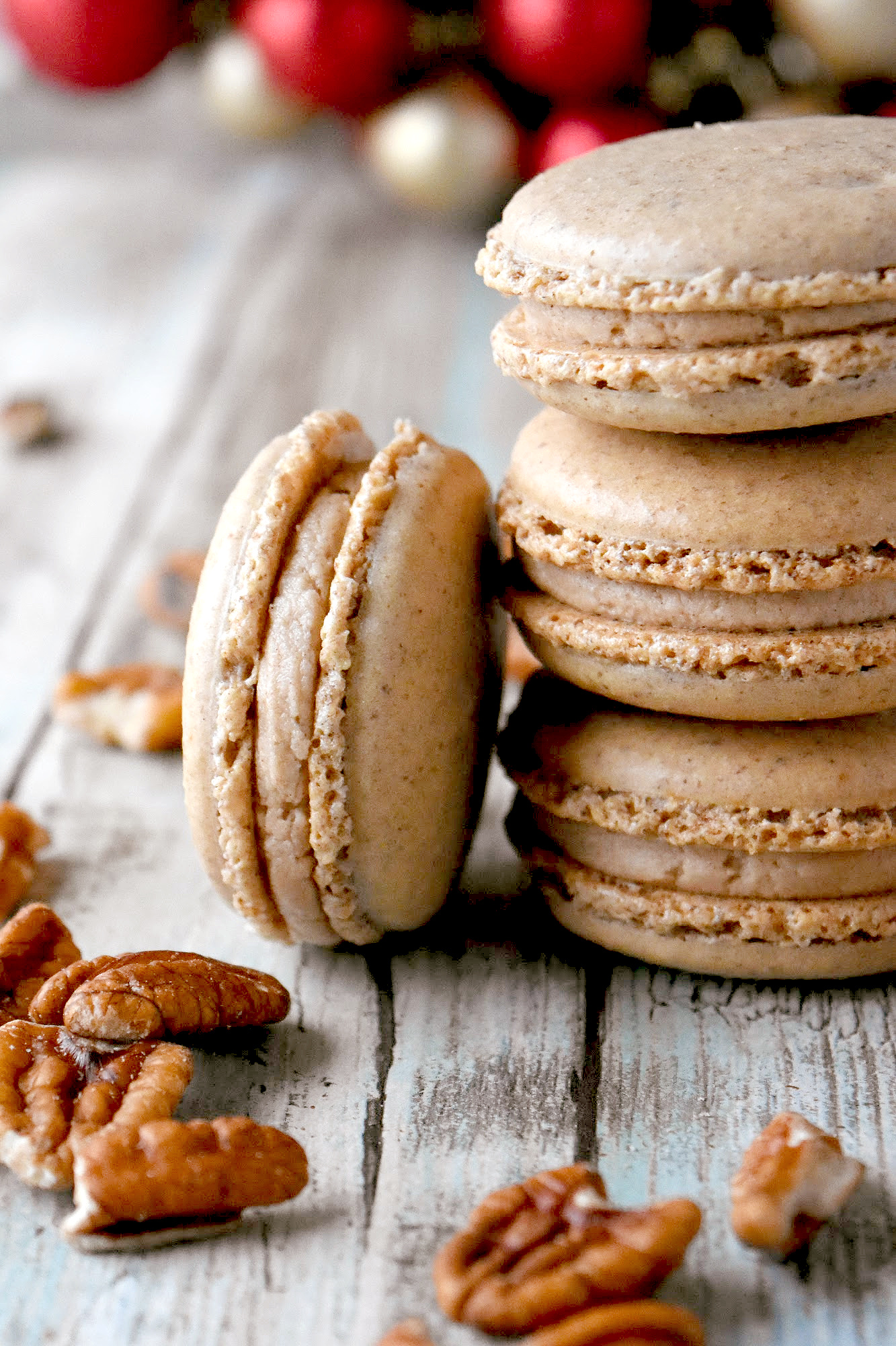 Cinnamon Pecan Macaron have the flavor of those fair cinnamon pecans in a macaron cookie.  They’re packed with pecan and cinnamon flavors with a hint of caramel in the filling. #ChristmasCookies