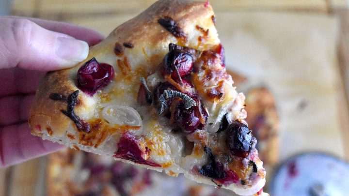 Cranberry and Prosciutto Pizza is cheesy and packed with roasted cranberries, fresh sage, prosciutto, and shallots. With a pre-made pizza dough, it’s a simple and simply delicious meal. #CranberryWeek