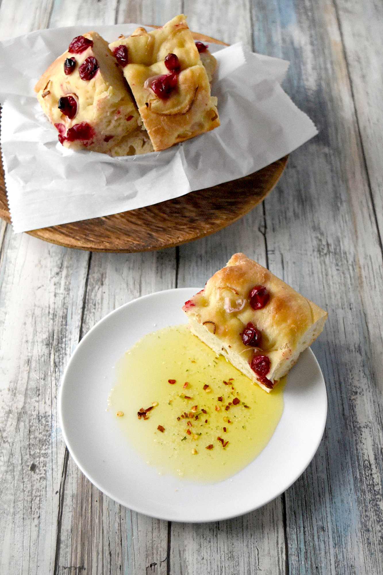 Cranberry Focaccia is super easy and mostly hands off.  It's topped with roasted cranberries and shallots and perfect dipped in olive. #CranberryWeek