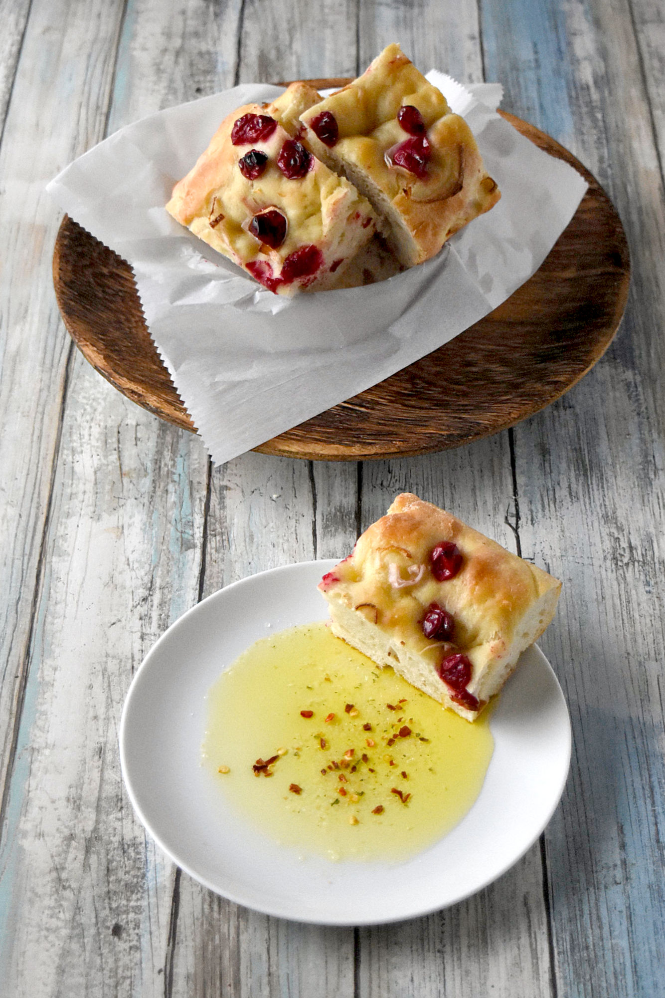 Cranberry Focaccia is super easy and mostly hands off.  It's topped with roasted cranberries and shallots and perfect dipped in olive. #CranberryWeek