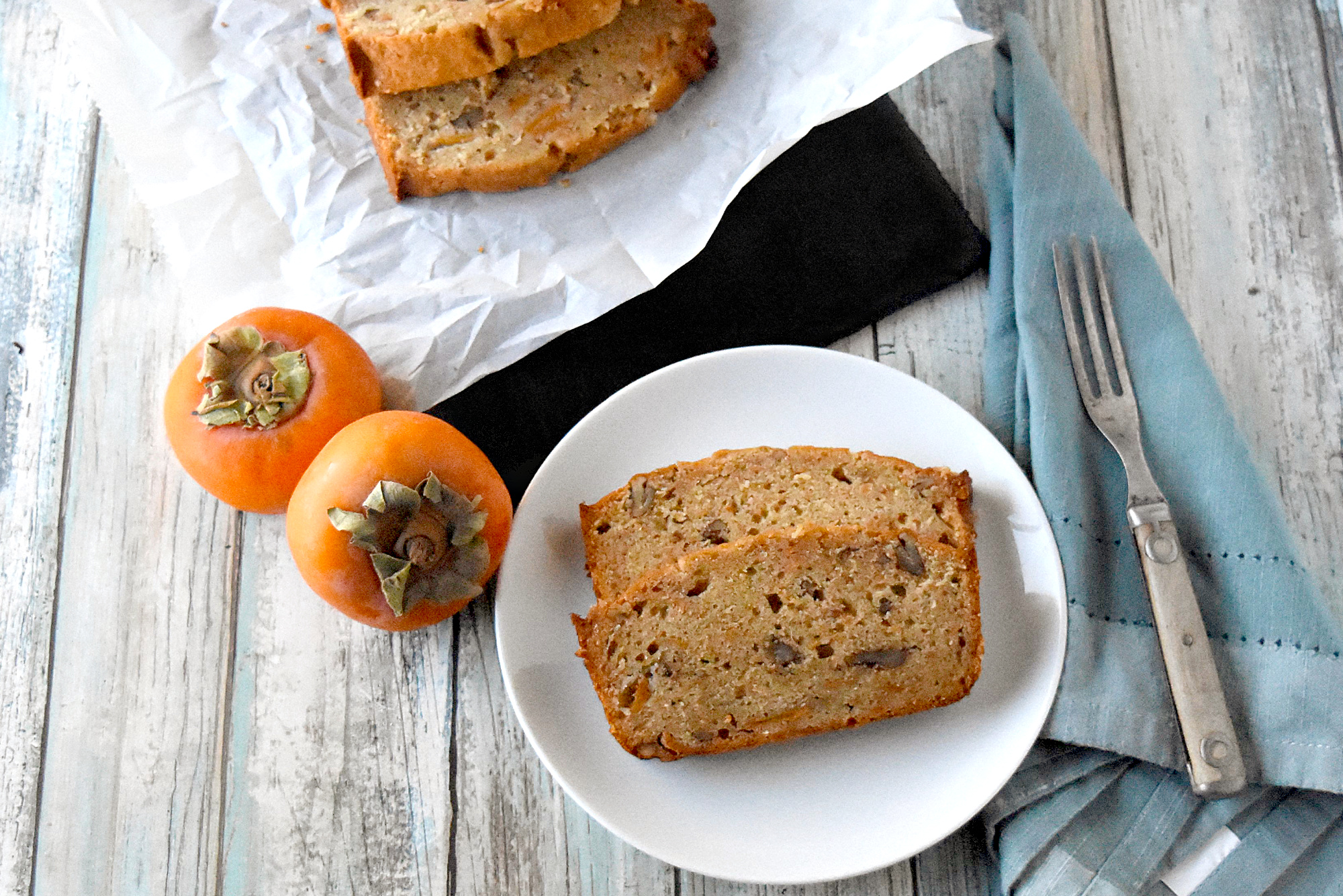 Bourbon Pecan Persimmon Bread has a hint of bourbon and persimmon packed with crunchy pecans. It’s moist, delicious, and packed full of deliciously ripe persimmons. #FamilyBakingChallenge #OurFamilyTable