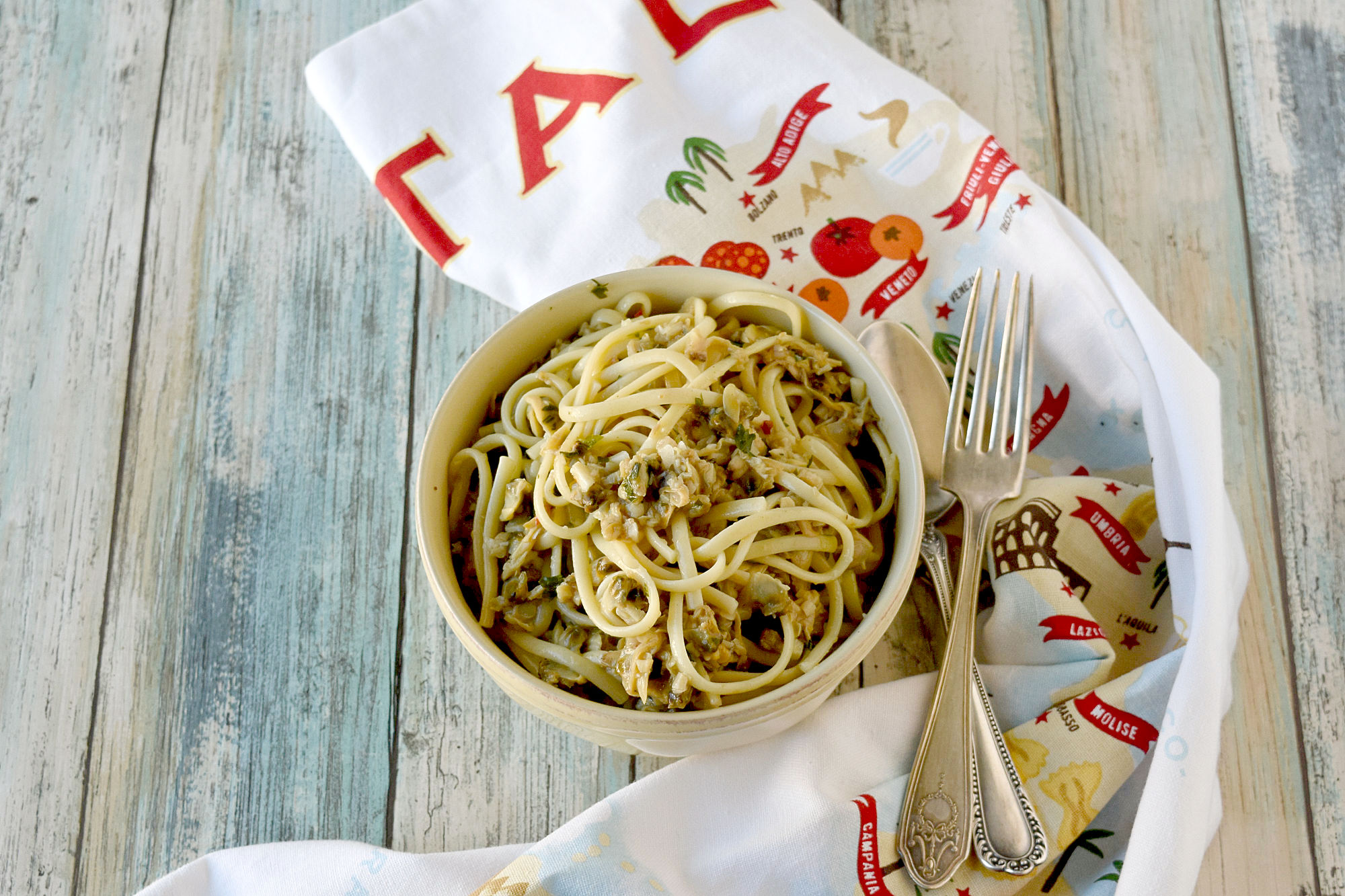 Easy Linguine with Clam Sauce uses pantry ingredients and comes together in a snap! It’s perfect for those busy weeknights and even fancy enough for a date dinner! #OurFamilyTable