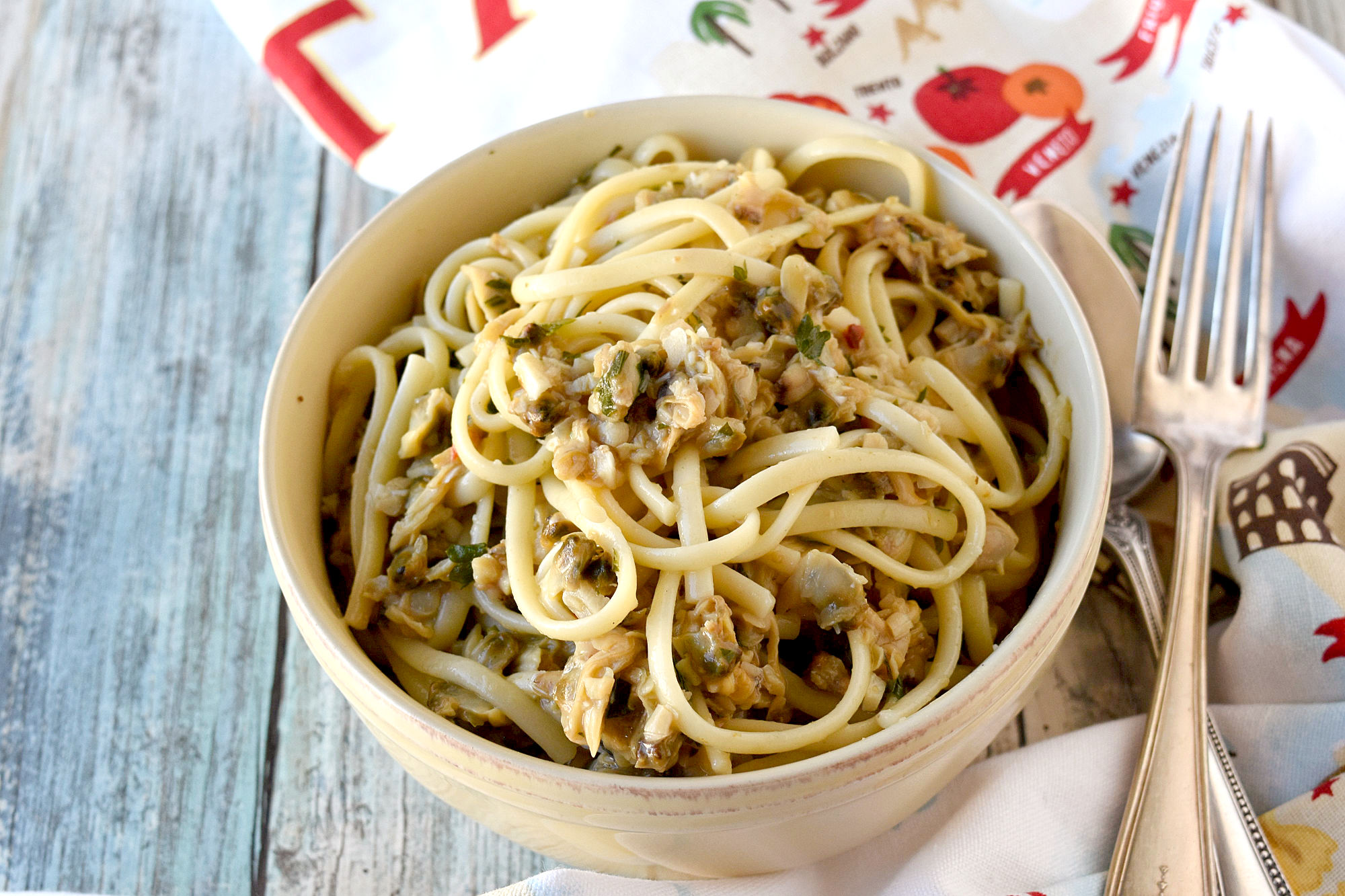 Easy Linguine with Clam Sauce uses pantry ingredients and comes together in a snap! It’s perfect for those busy weeknights and even fancy enough for a date dinner! #OurFamilyTable