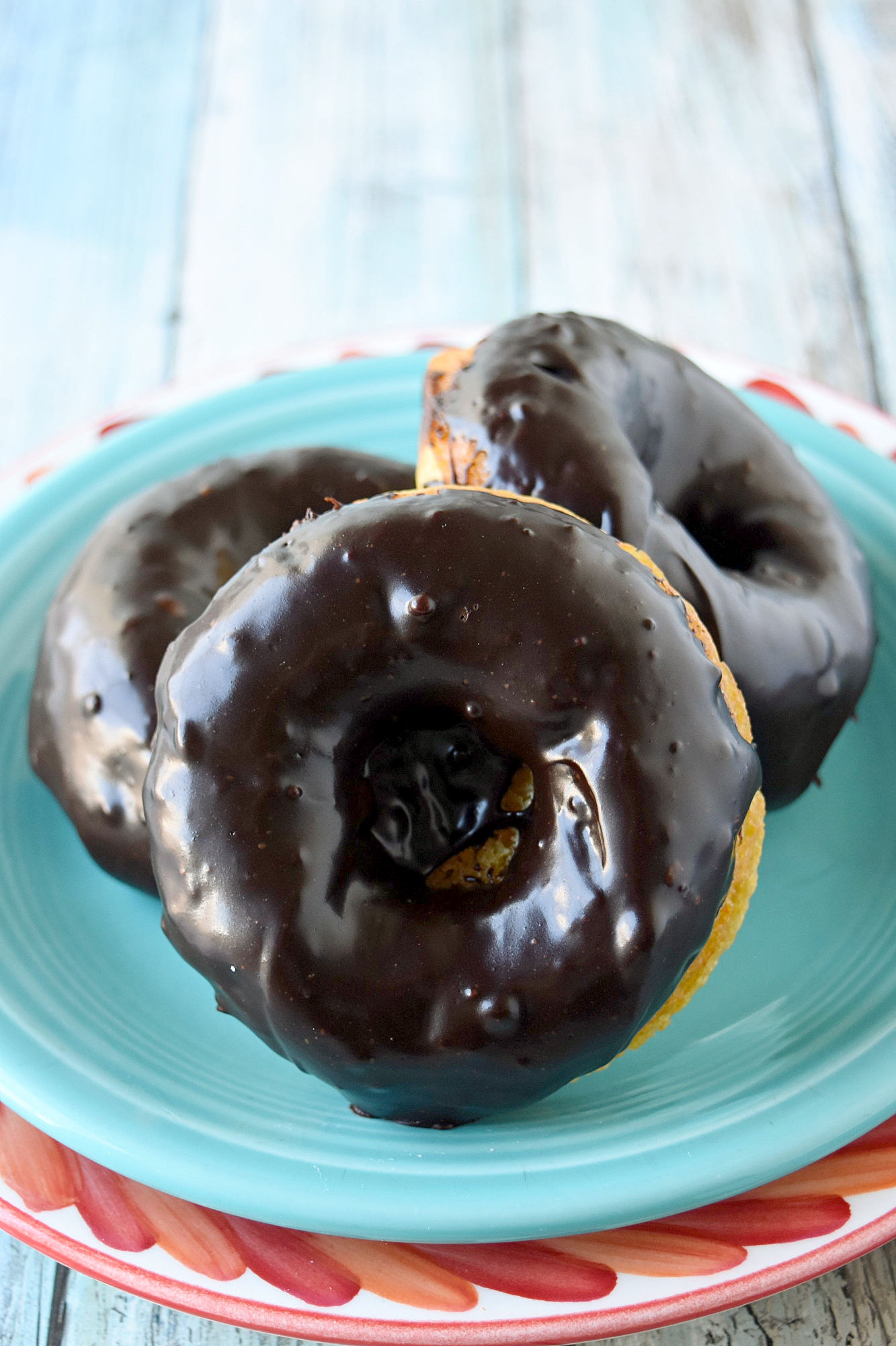 Mandarin Orange Donuts with Ganache Glaze are packed with mandarin orange flavor in a tender baked donut wrapper.  The chocolate scented ganache glaze is an added bonus. #SpringSweetsWeek