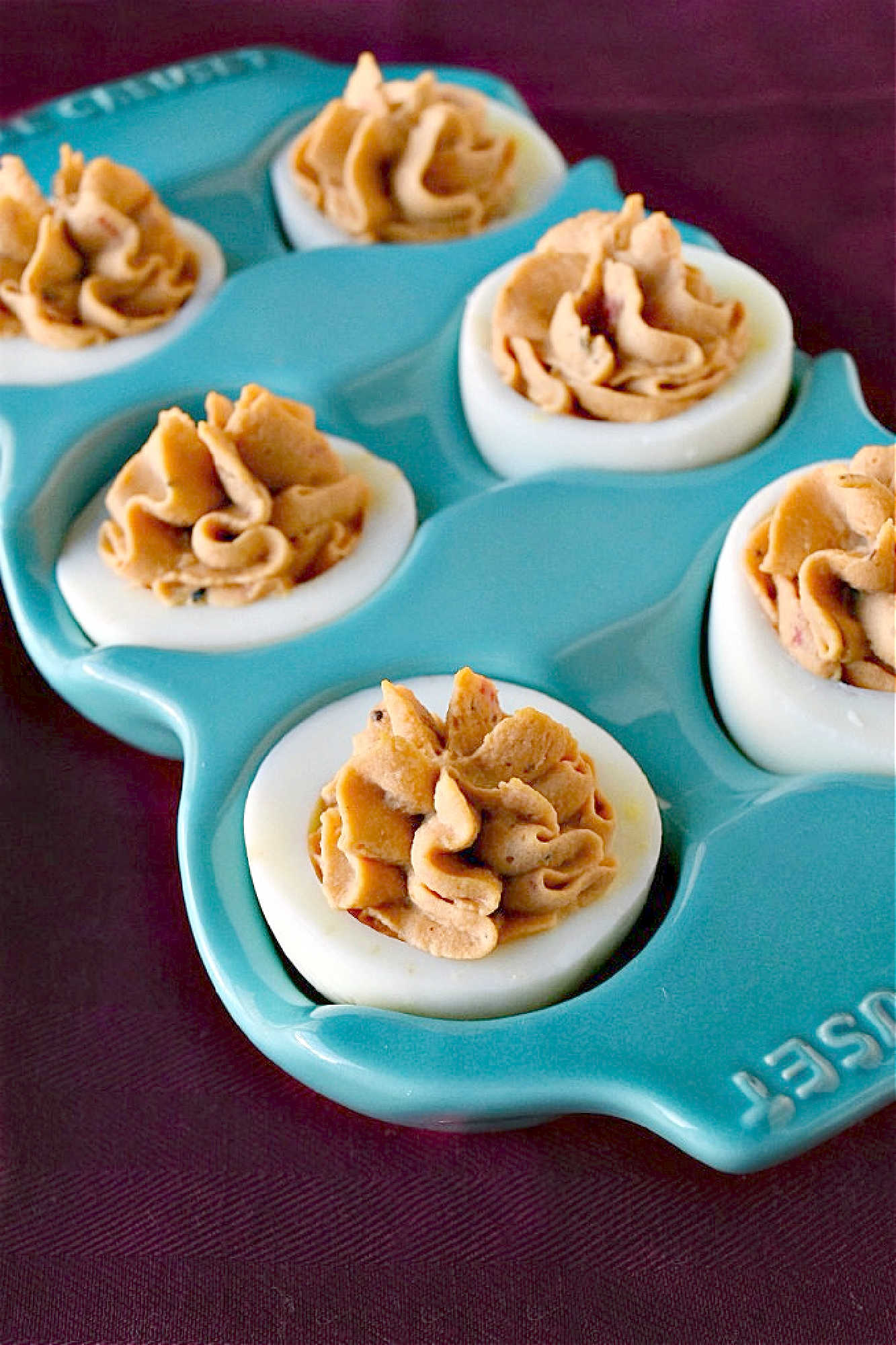 Spice up your feed (and your party menu!) with this flavorful twist on a classic: Middle Eastern Deviled Eggs! Made with 2 kinds of creamy hummus and roasted red peppers, then added a punch of za'atar and sumac for a zesty, savory kick that’s seriously addictive. #deviledeggs #hummus #Easter #MiddleEasternEats #DeviledEggPerfection #SavorySnacks #EggcellentRecipes #FlavorsofTheLevant