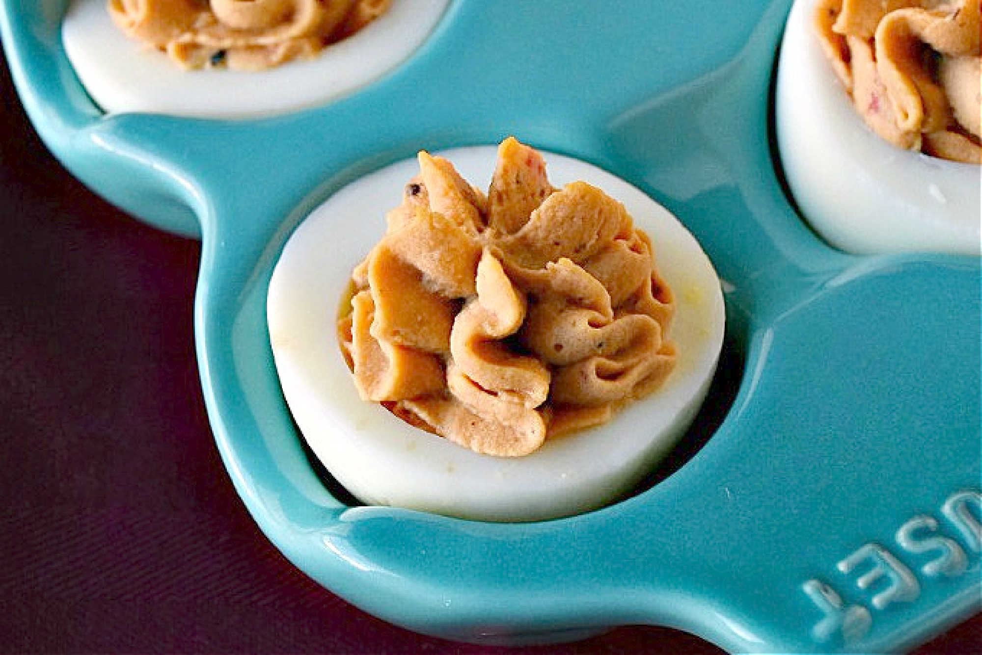 Spice up your feed (and your party menu!) with this flavorful twist on a classic: Middle Eastern Deviled Eggs! Made with 2 kinds of creamy hummus and roasted red peppers, then added a punch of za'atar and sumac for a zesty, savory kick that’s seriously addictive. #deviledeggs #hummus #Easter #MiddleEasternEats #DeviledEggPerfection #SavorySnacks #EggcellentRecipes #FlavorsofTheLevant