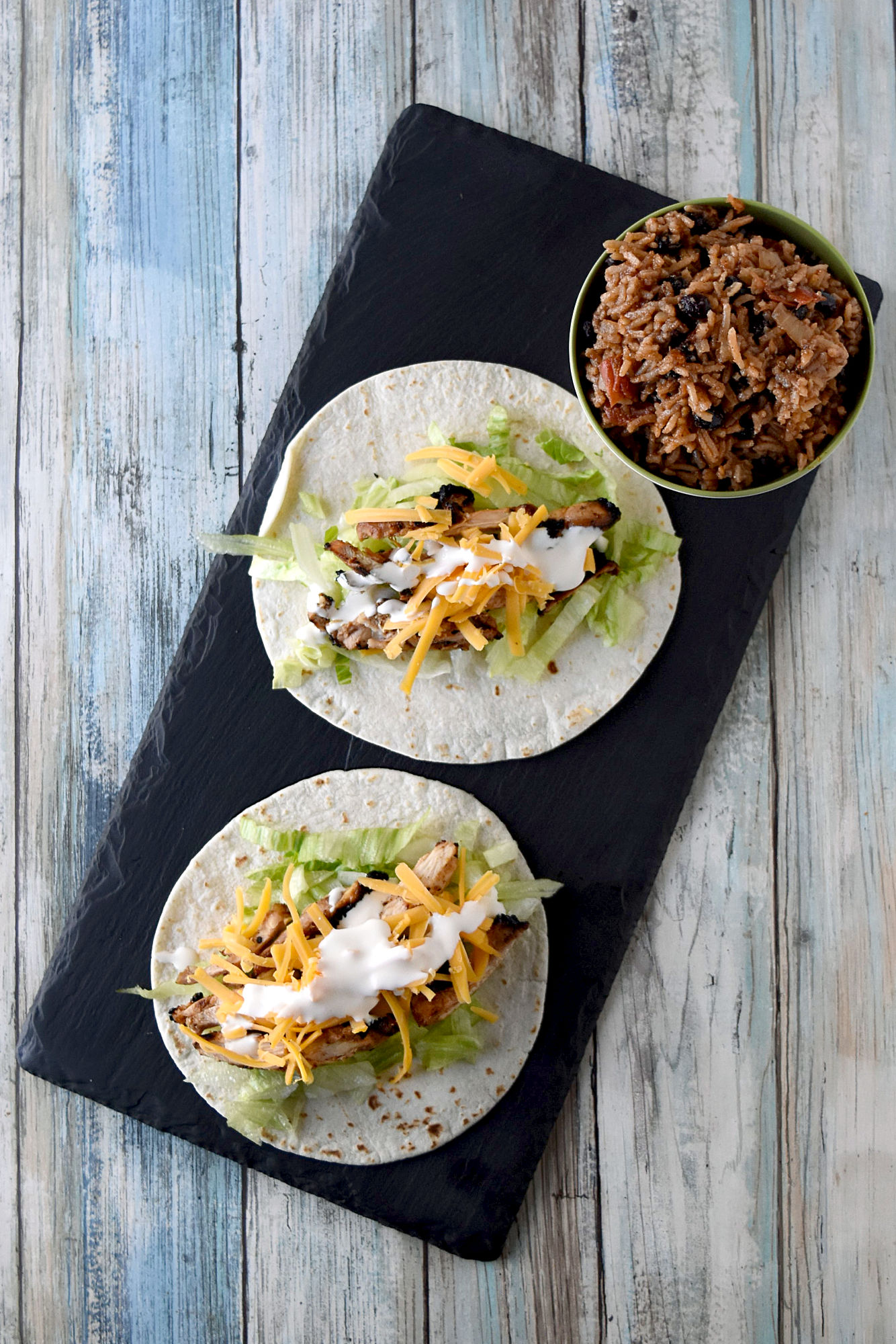 Cuban Marinated Chicken Tacos are marinated with orange and lime juice, cumin, garlic, and minced onion. Boneless, skinless chicken thighs means they grill up quick for any night of the week. #BBQWeek