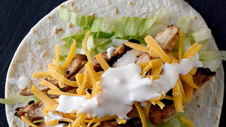 Cuban Marinated Chicken Tacos are marinated with orange and lime juice, cumin, garlic, and minced onion.  Boneless, skinless chicken thighs means they grill up quick for any night of the week. #BBQWeek