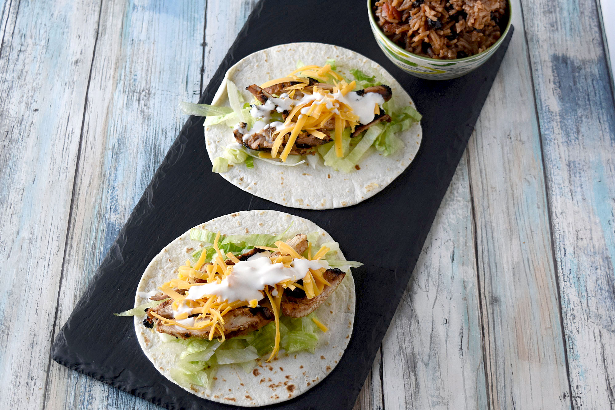 Cuban Marinated Chicken Tacos are marinated with orange and lime juice, cumin, garlic, and minced onion. Boneless, skinless chicken thighs means they grill up quick for any night of the week. #BBQWeek