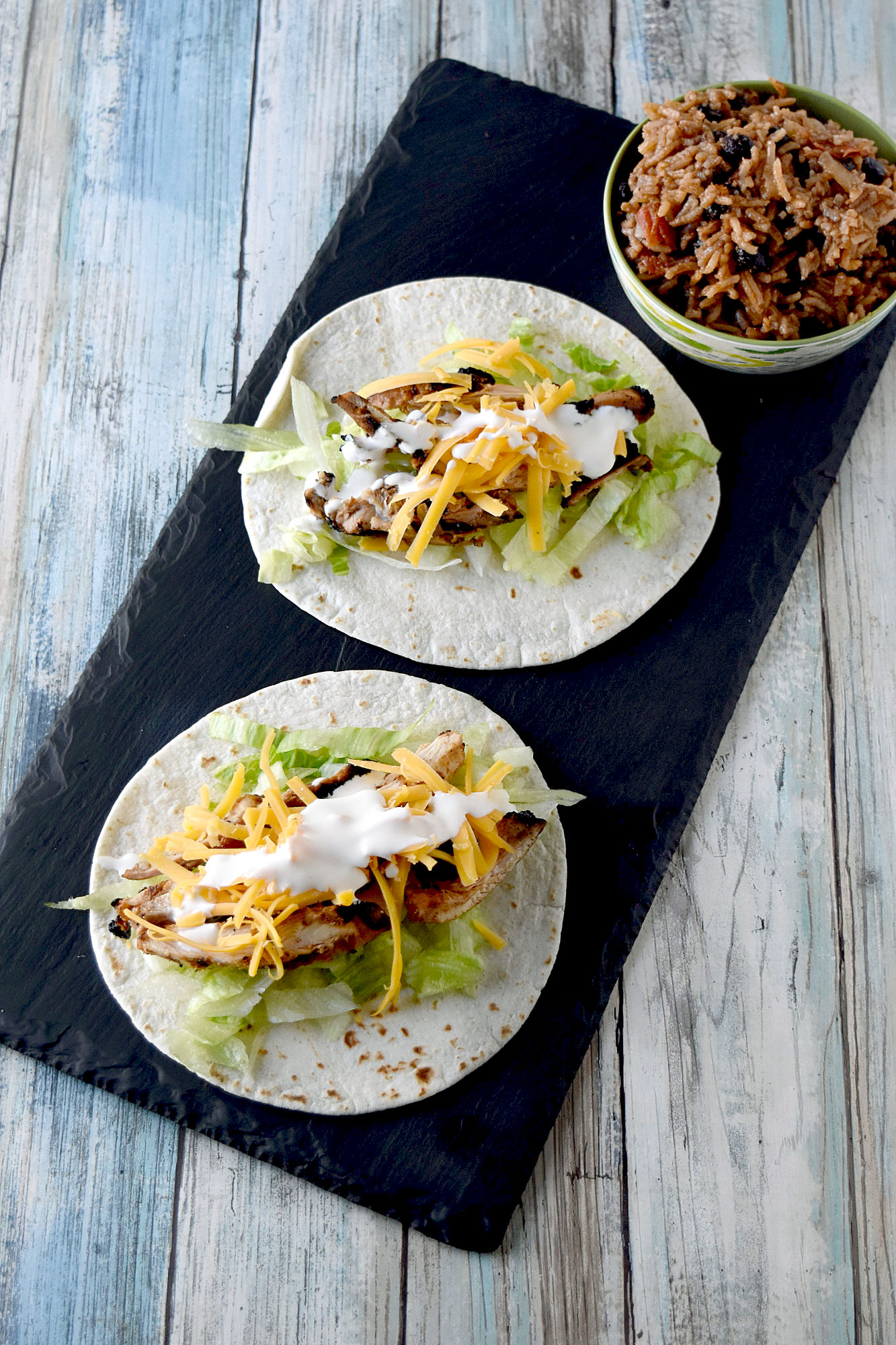 Cuban Marinated Chicken Tacos are marinated with orange and lime juice, cumin, garlic, and minced onion.  Boneless, skinless chicken thighs means they grill up quick for any night of the week. #BBQWeek