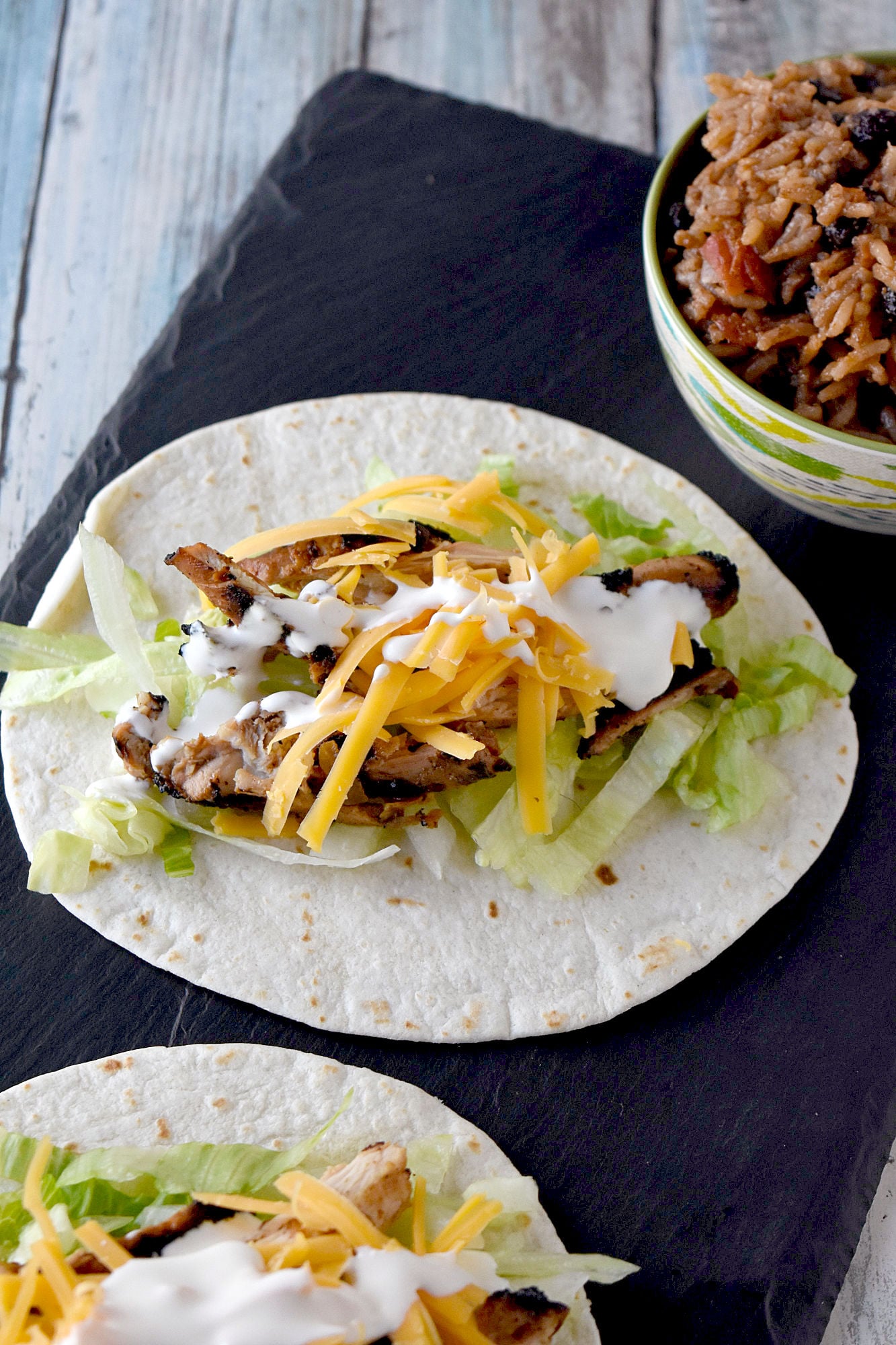 Cuban Marinated Chicken Tacos are marinated with orange and lime juice, cumin, garlic, and minced onion. Boneless, skinless chicken thighs means they grill up quick for any night of the week. #BBQWeek