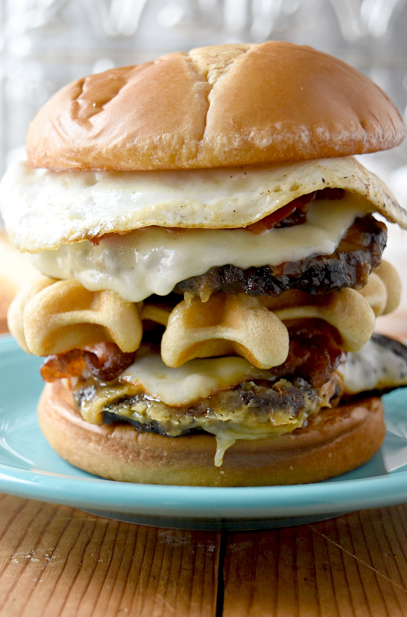 Double Decker Brunch Burger is just that. Brunch on a bun. It starts with two smashed patties topped with cheese. The top layer has a fried egg and bacon and there’s a waffle in the middle making it an epic double decker burger. #BurgerMonth