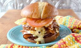 The Hot Brown Burger is a double decker turkey burger topped with bacon, tomato, and a rich cheddar Mornay sauce. Grab a bib because this burger is deliciously messy. #BurgerMonth