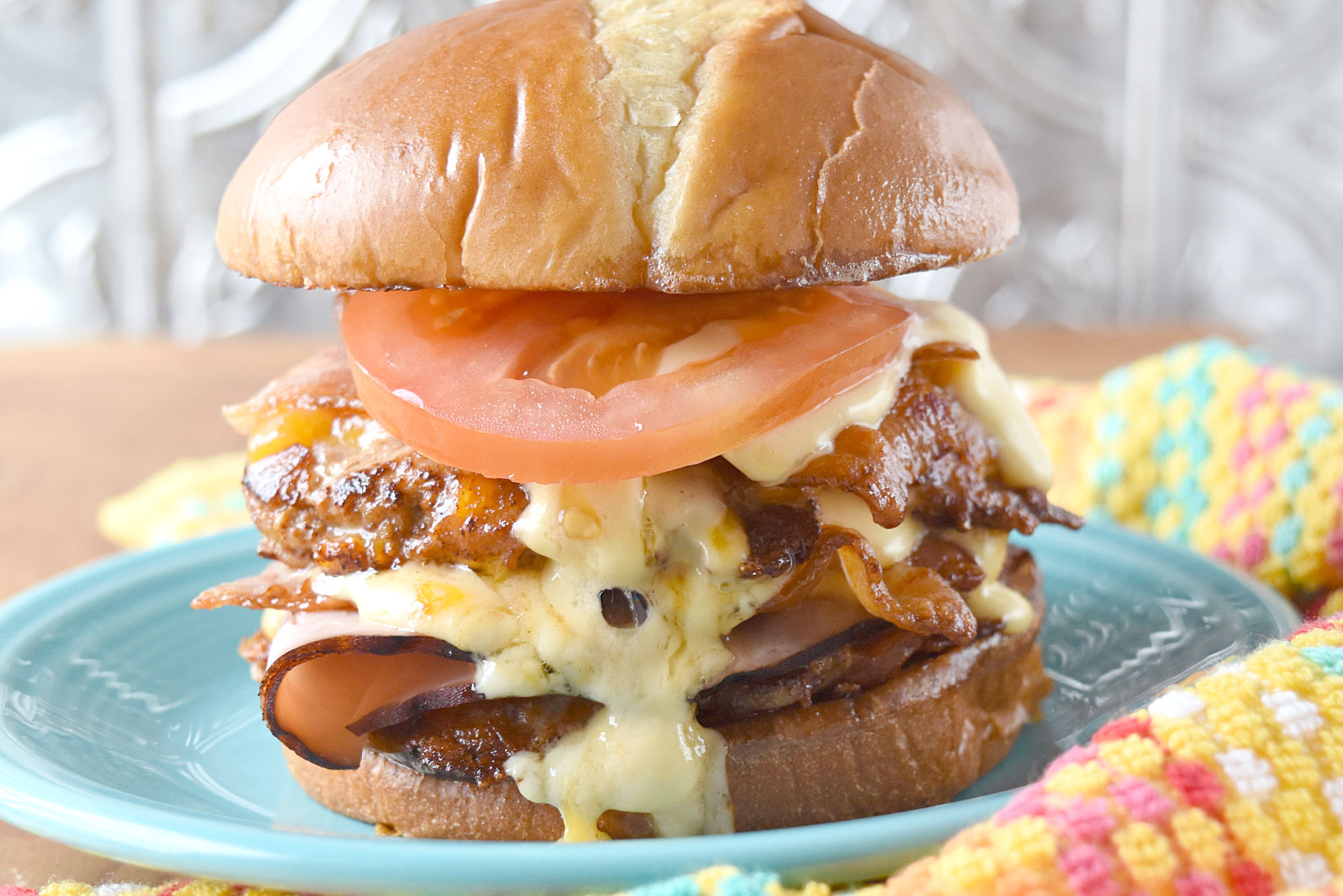 The Hot Brown Burger is a double decker turkey burger topped with bacon, tomato, and a rich cheddar Mornay sauce.  Grab a bib because this burger is deliciously messy. #BurgerMonth