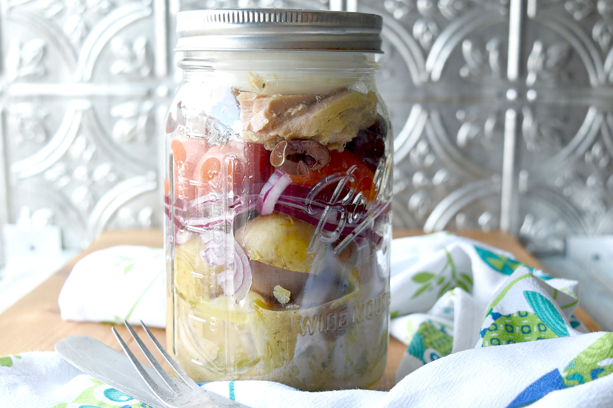 Layered Mason Jar Niçoise Salad is perfect for a hearty and delicious office lunch.  Or make several for a fun lunch in the park. #OurFamilyTable