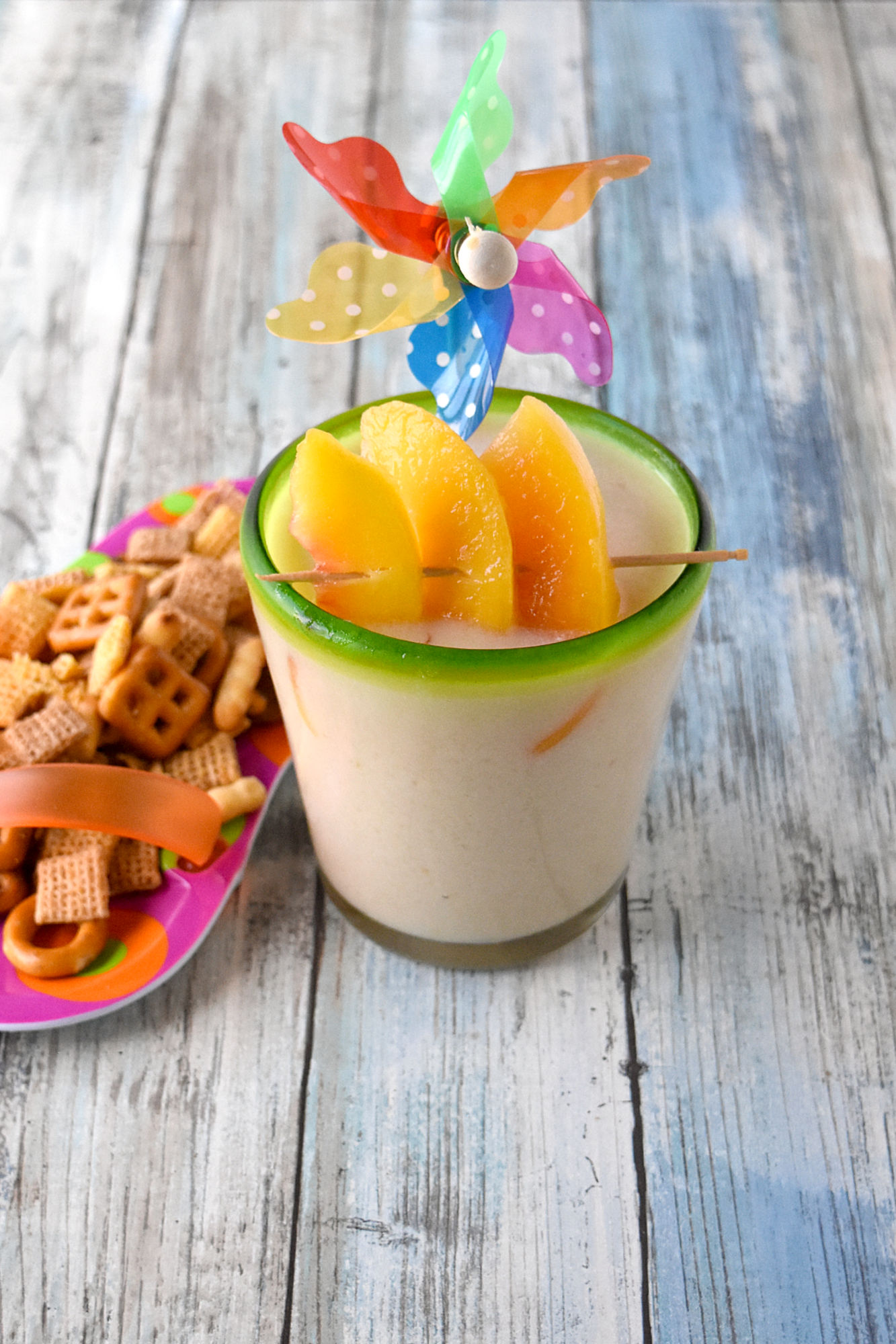 Peachy Colada has simple ingredients and tastes perfectly delicious.  Made with frozen peaches, 2 types of rum, and crema of coconut, it's a refreshing summer colada you'll enjoy. #OurFamilyTable