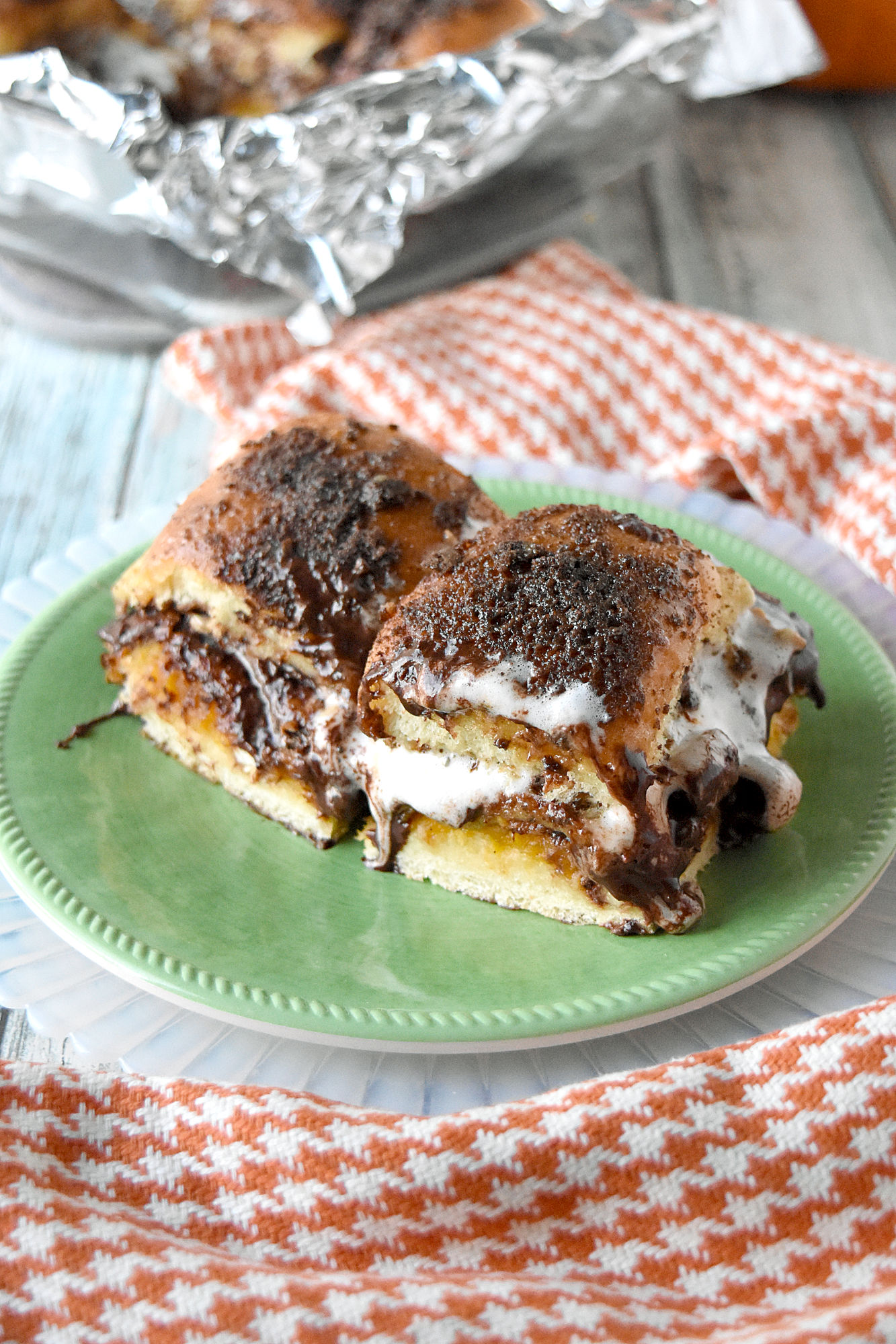 Pumpkin S'Mores Sliders are easy to make, are messy to eat, and taste perfectly delicious.  The combination of the spiced pumpkin, chocolate, pecans, and caramel sauce are perfect with the sweet Hawaiian rolls. #PumpkinWeek