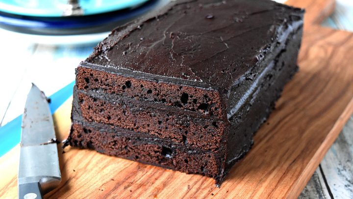 Deadly Dark Chocolate Layer Cake has two kinds of dark chocolate in it along with some coffee. The frosting is also a dark chocolate frosting making this one dangerous cake. One bite and you will be addicted. #HalloweenTreatsWeek
