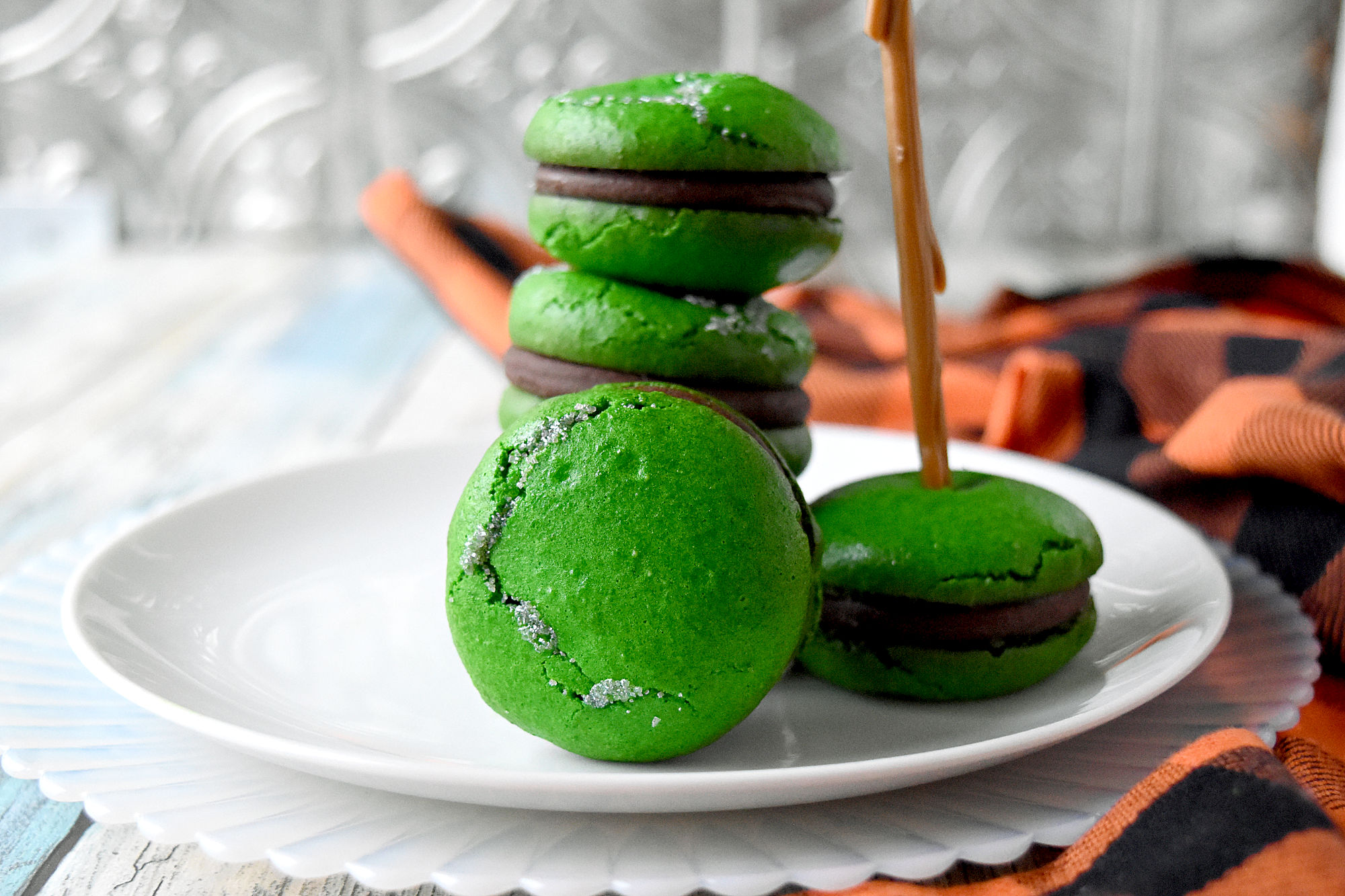 Poisoned Apple Macaron have freeze dried apples in the shells and apple simple syrup in the chocolate filling.  Don't let the color fool you!  They are perfectly delicious and totally not poisoned! #HalloweenTreatsWeek