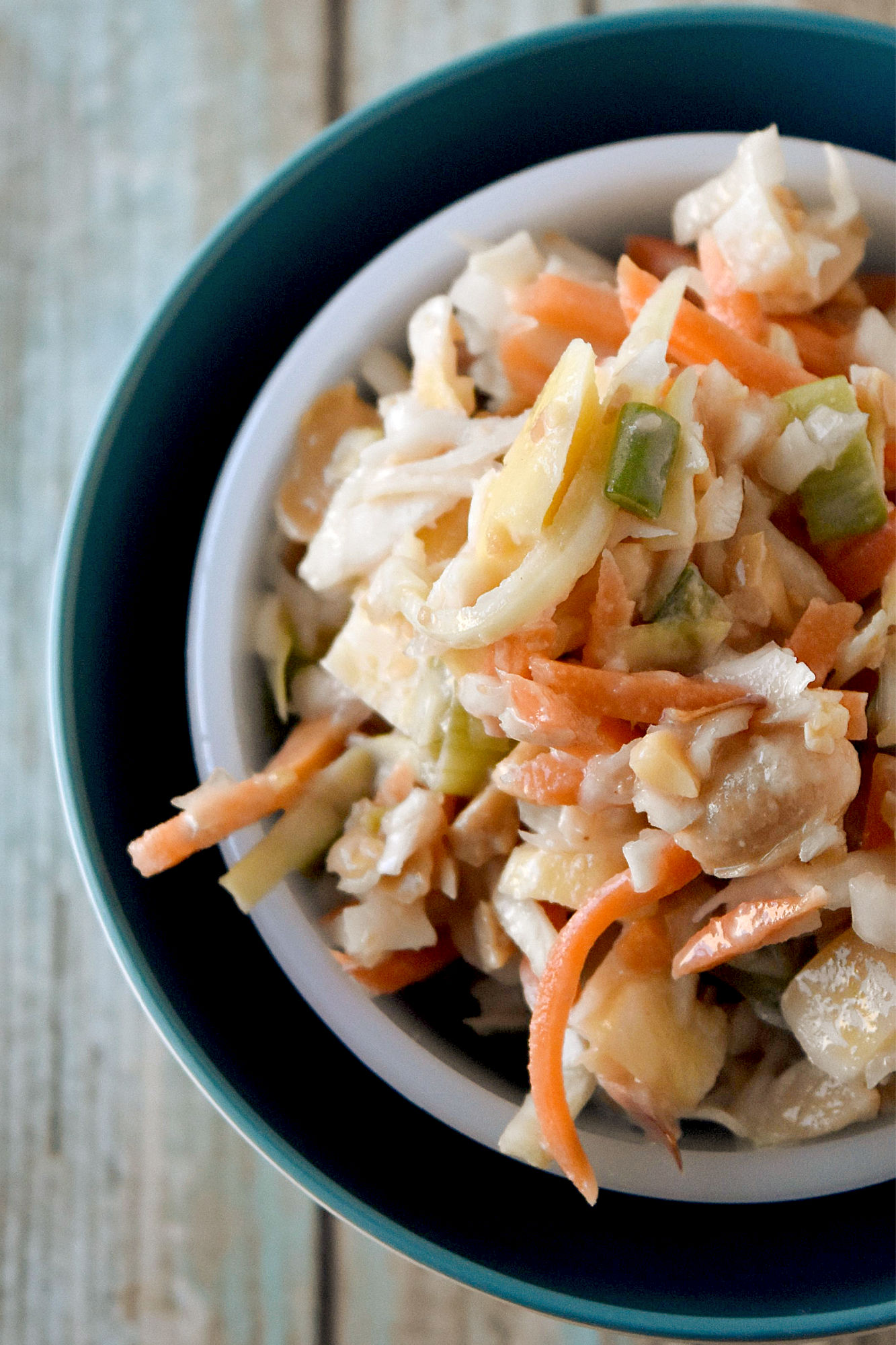 Carrot Peanut Slaw has a twist on a southern classic. This slaw is lime juice, grated ginger, and chopped dried mango for a tropical twist to the classic side dish. #HolidaySideDishes