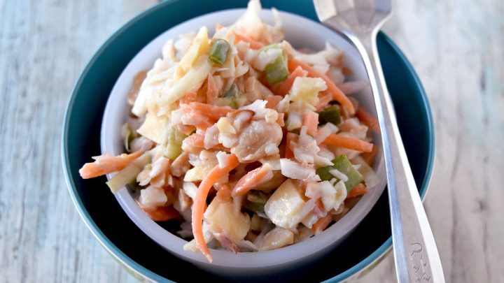 Carrot Peanut Slaw has a twist on a southern classic. This slaw is lime juice, grated ginger, and chopped dried mango for a tropical twist to the classic side dish. #HolidaySideDishes