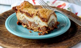 Meatball Lasagna has layers of homemade Italian meatballs with sauce and ricotta with Parmesan.  It assembles quickly with precooked meatballs, a jar of sauce, and noodles. #OurFamilyTable