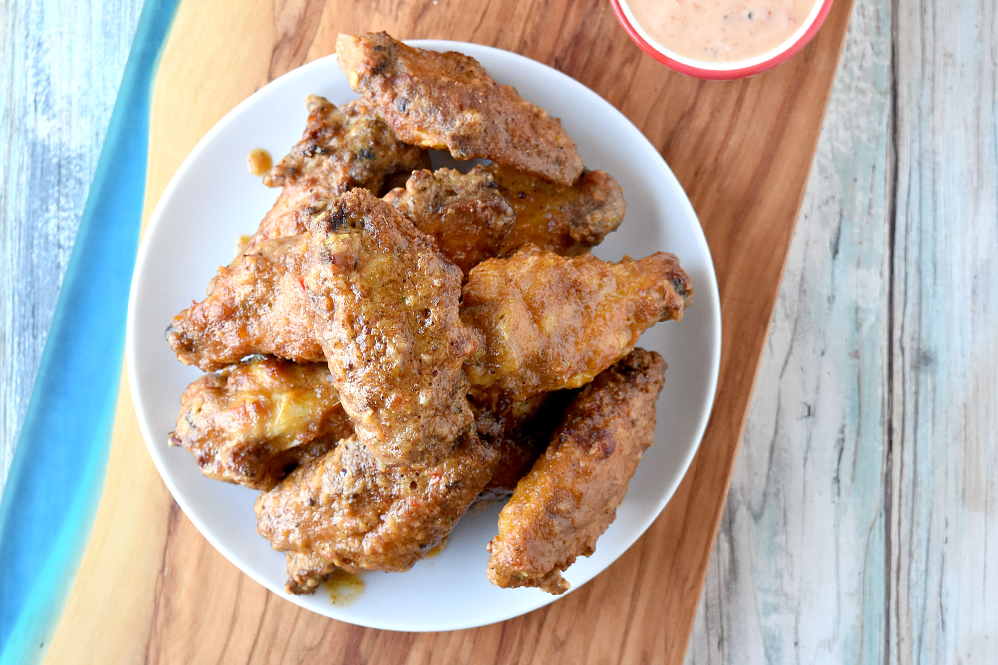 Sambal Crispy Air Fryer Wings are coated in Filipino grill spice and a secret ingredient before air frying. After cooking, they are tossed in a sambal butter sauce giving them a spicy kick. #SeriousFoodieRecipeChallenge, #SeriousFoodie, #BitesAroundTheWorld