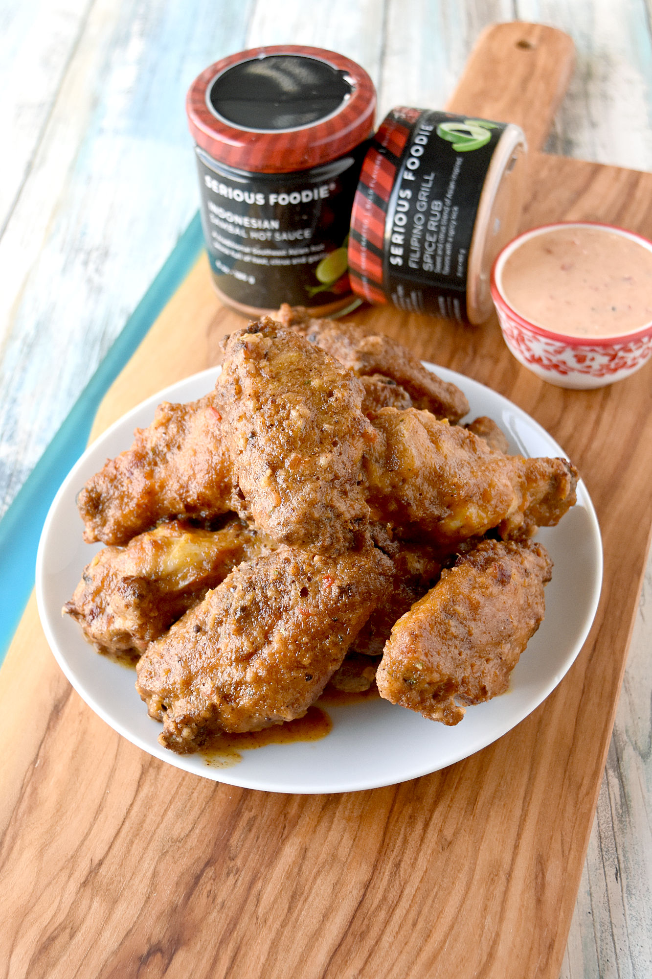Sambal Crispy Air Fryer Wings are coated in Filipino grill spice and a secret ingredient before air frying. After cooking, they are tossed in a sambal butter sauce giving them a spicy kick. #SeriousFoodieRecipeChallenge, #SeriousFoodie, #BitesAroundTheWorld