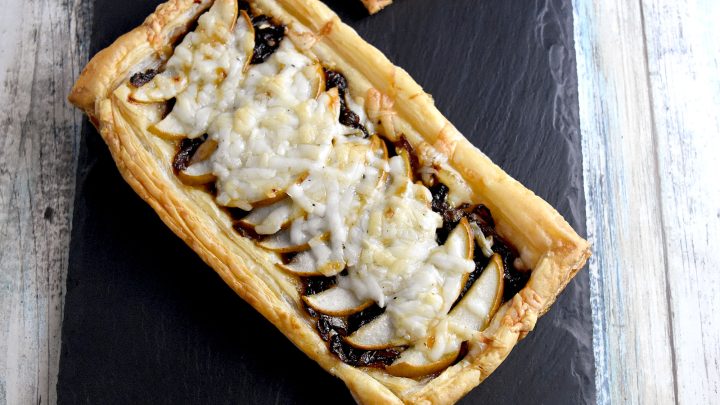 Caramelized Onion and Pear Tart is a perfect New Year’s finger food!  Sweet, caramelized onions, pears, and truffle goat cheese come together in puff pastry for a delicious appetizer. #OurFamilyTable