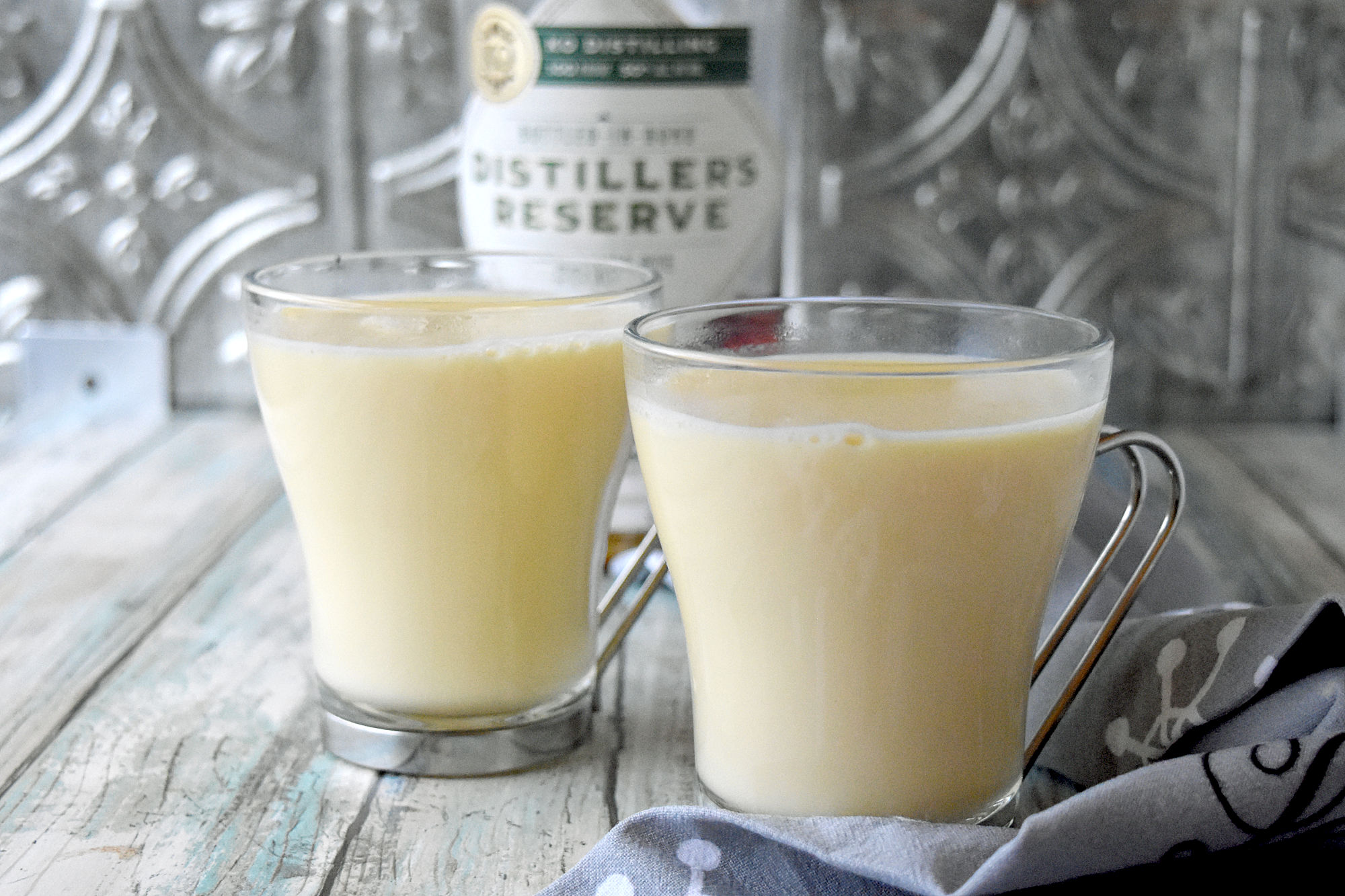 Spiked Eggnog White Hot Chocolate is full of eggnog flavor and rich with white chocolate.  It has a kick from the Distiller’s Reserve Bottled-in-Bond Rye Whiskey. #OurFamilyTable