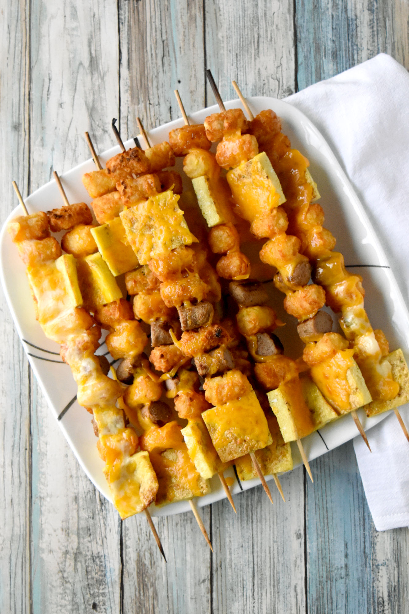 Breakfast Totcho Kabobs are fun and quick! The eggs and sausage bake while the tots air fry making these super easy to make. 