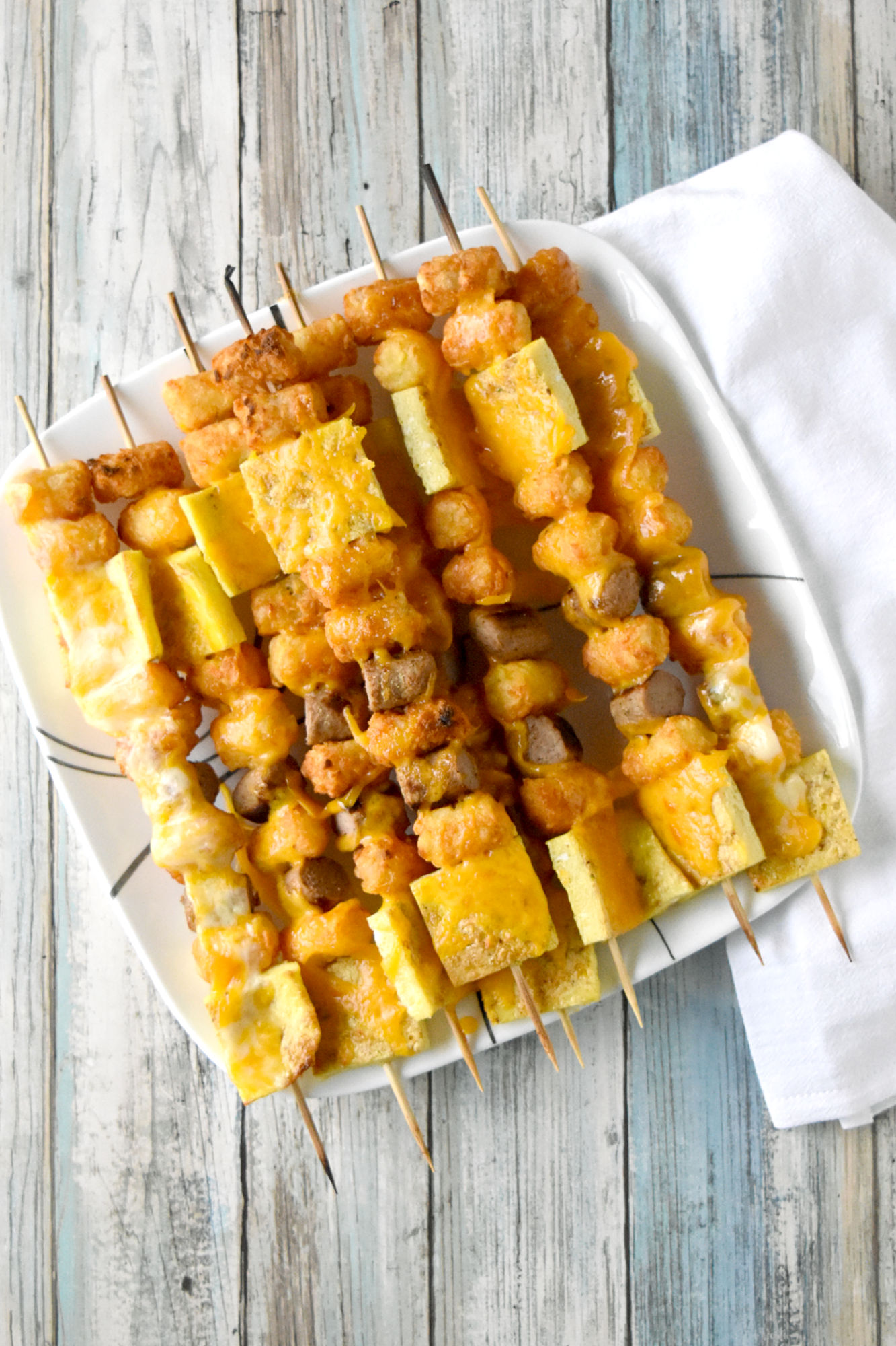 Breakfast Totcho Kabobs are fun and quick! The eggs and sausage bake while the tots air fry making these super easy to make. 