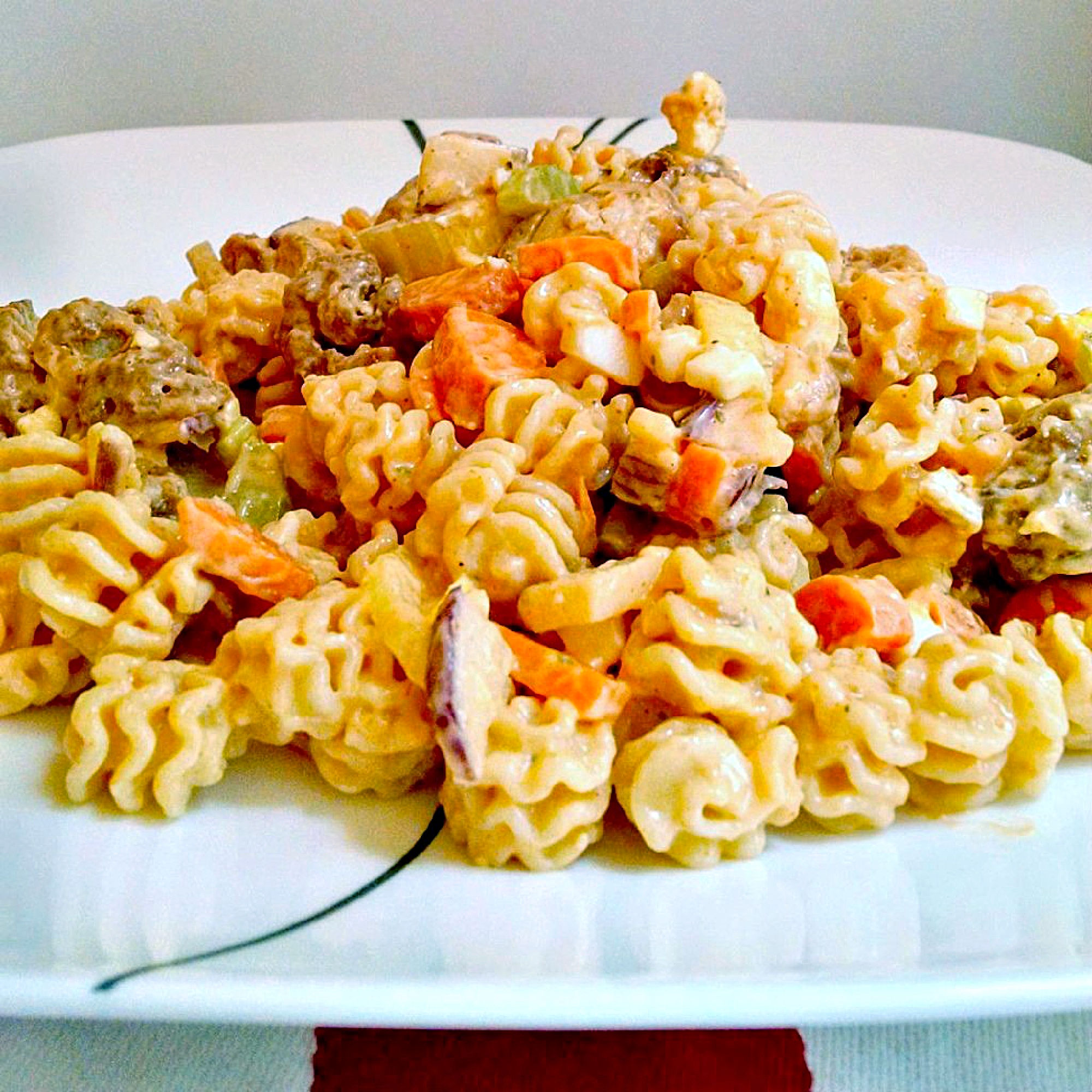 Buffalo Chicken Pasta Salad uses leftover buffalo chicken rotisserie chicken to make a deliciously quick and spicy weeknight dinner, but you could use any boneless and skinless chicken you have available. #OurFamilyTable