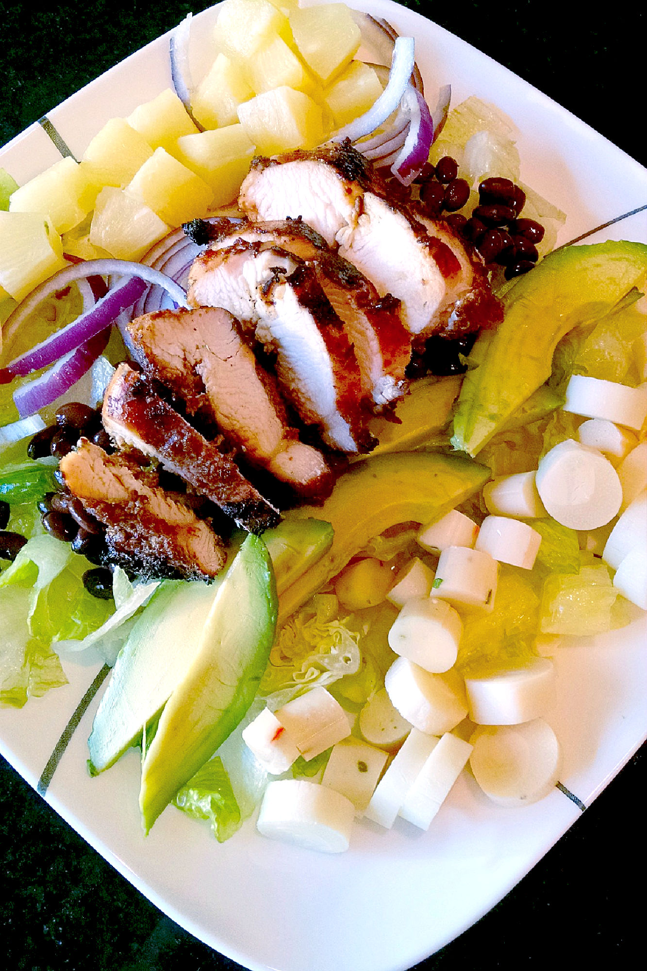 A delicious Caribbean twist to the cobb salad, this Calypso Caribbean Cobb Salad has hearts of palm, pineapple, and jerk marinated chicken that transports you to the islands.