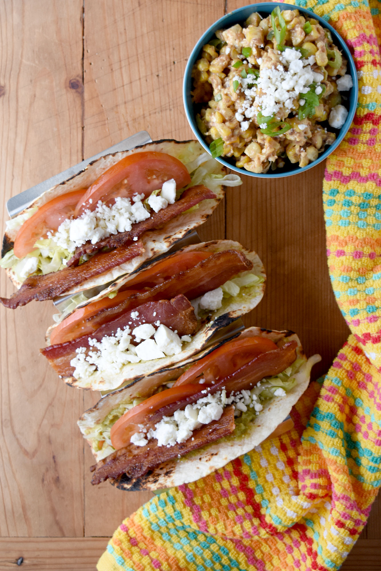 BLT Tacos are a fun twist on the classic sandwich.  This recipe replaces mayonnaise with fresh guacamole and highlights in season tomatoes. #OurFamilyTable #baconrecipe #bltrecipe #bacon #taco 