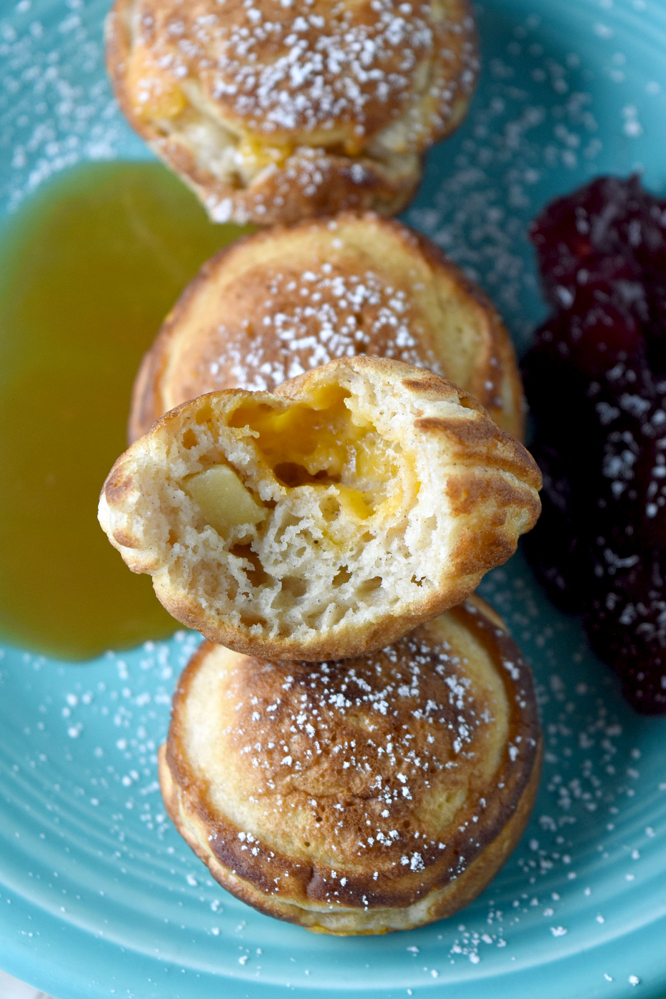 Apple Cheddar Ebelskiver are little pockets of pancake goodness filled with sweet apples and tangy Cheddar.  They’re fun for a brunch, snack, or just because you want to make something a little different.  #FallFlavors #ebelskiver #apple #cheddar #pancakes