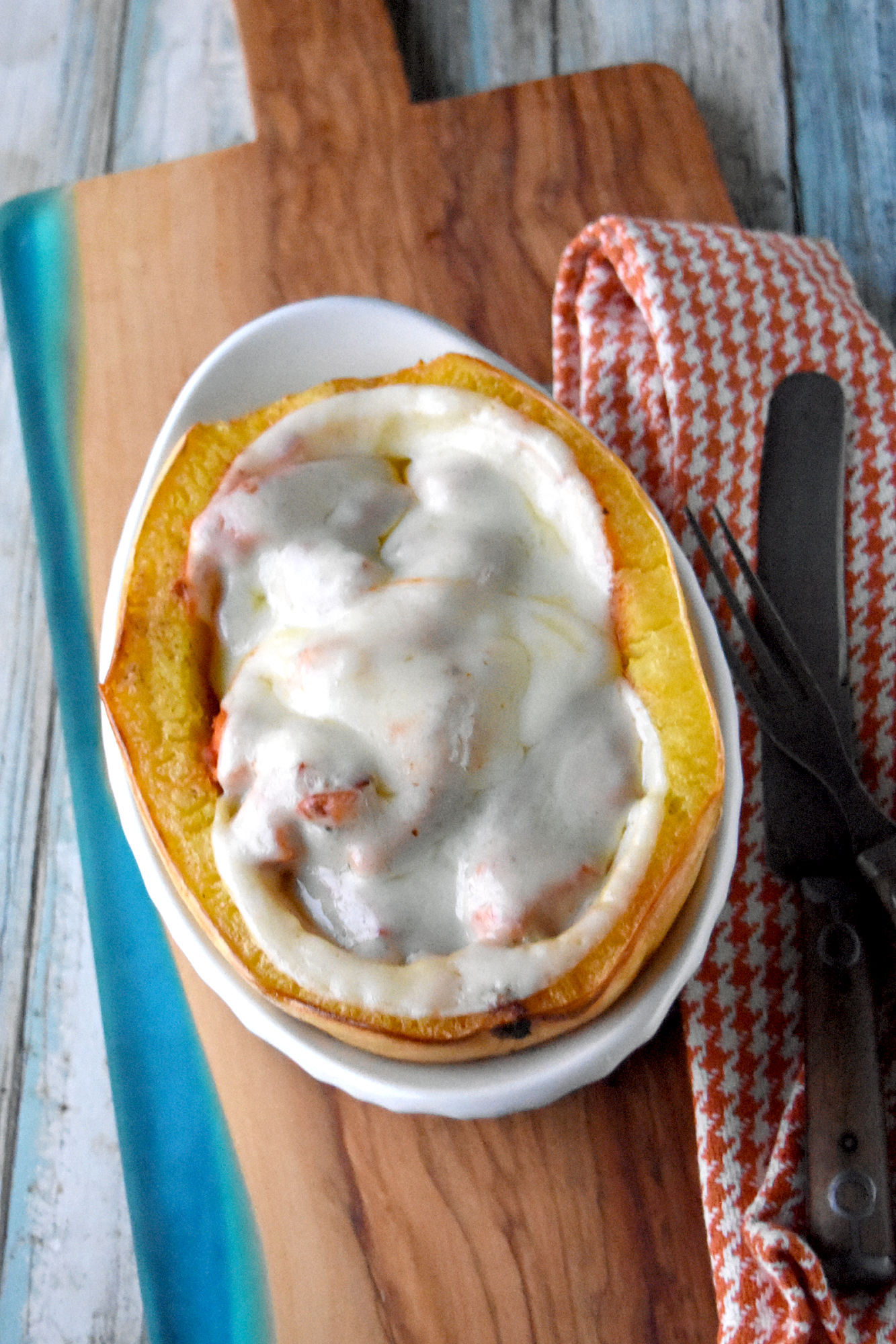 Chicken Parm Stuffed Spaghetti Squash is a light but hearty dinner.  It’s light because it’s made with chicken breast and squash, but hearty because they are both very filling!  #FallFlavors #spaghettisquash #ChickenParm 